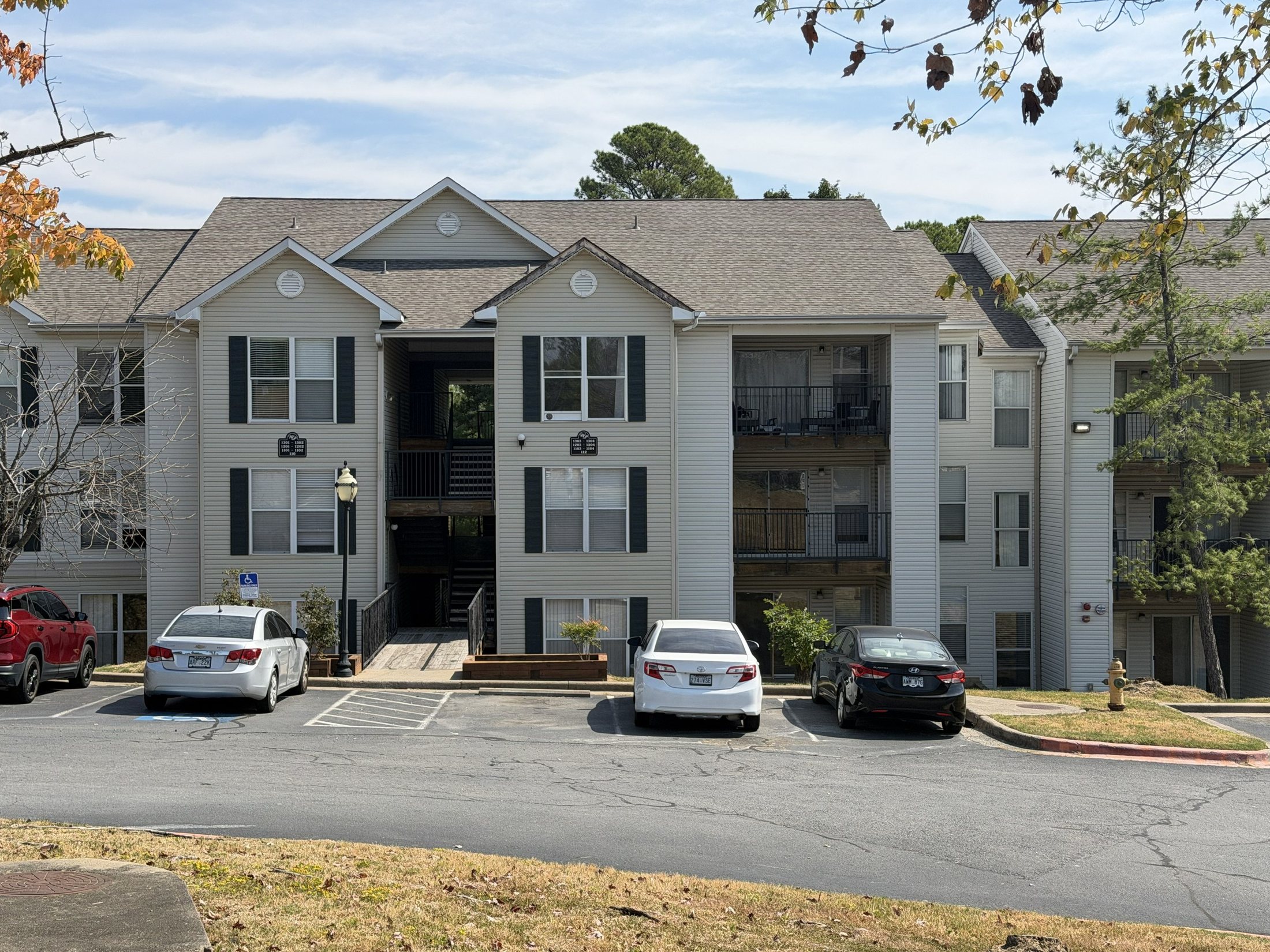 Before: the building with dated siding and worn lawn