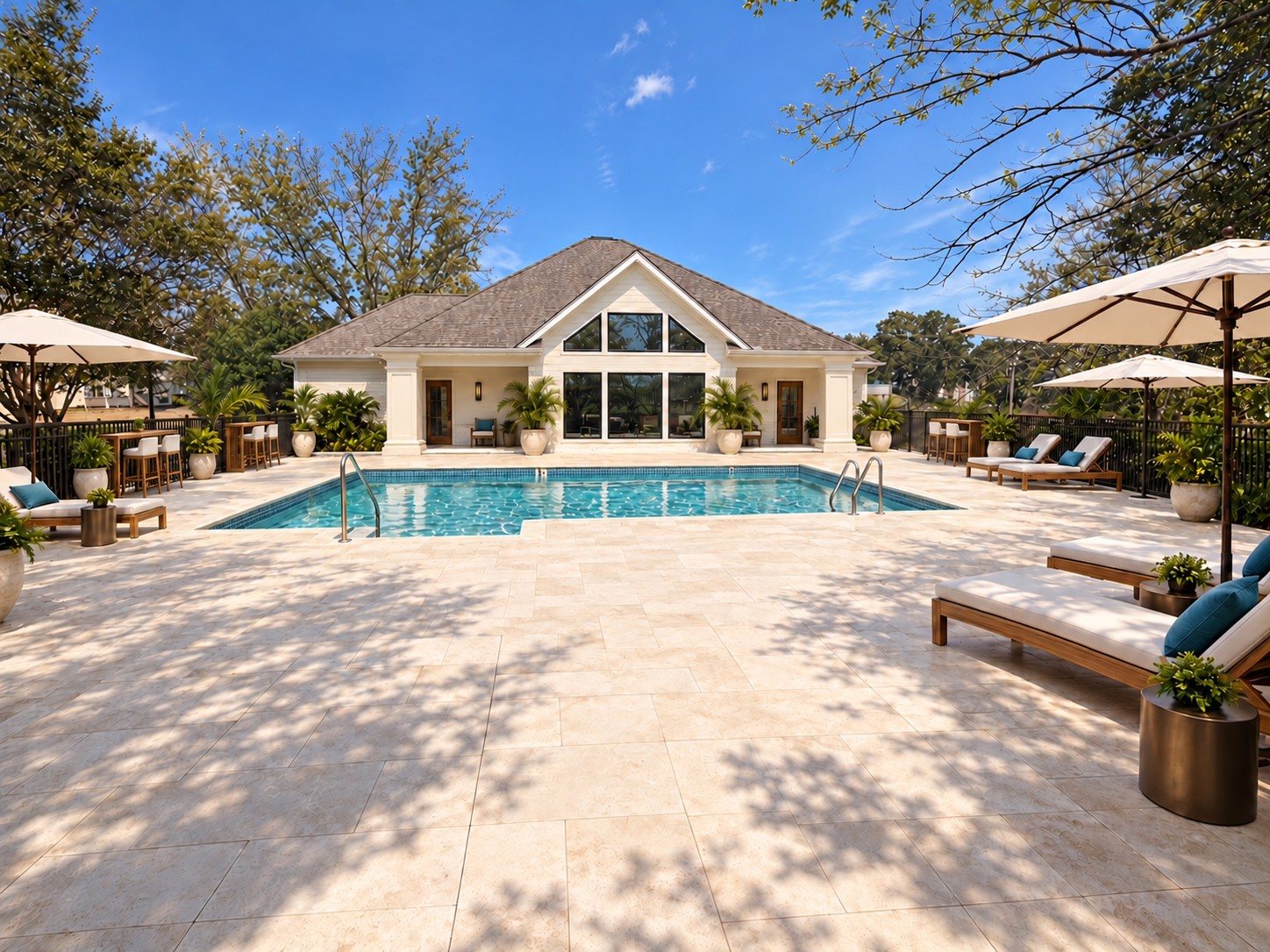 After: the clubhouse rear with tropical planting, loungers and umbrellas beside the pool