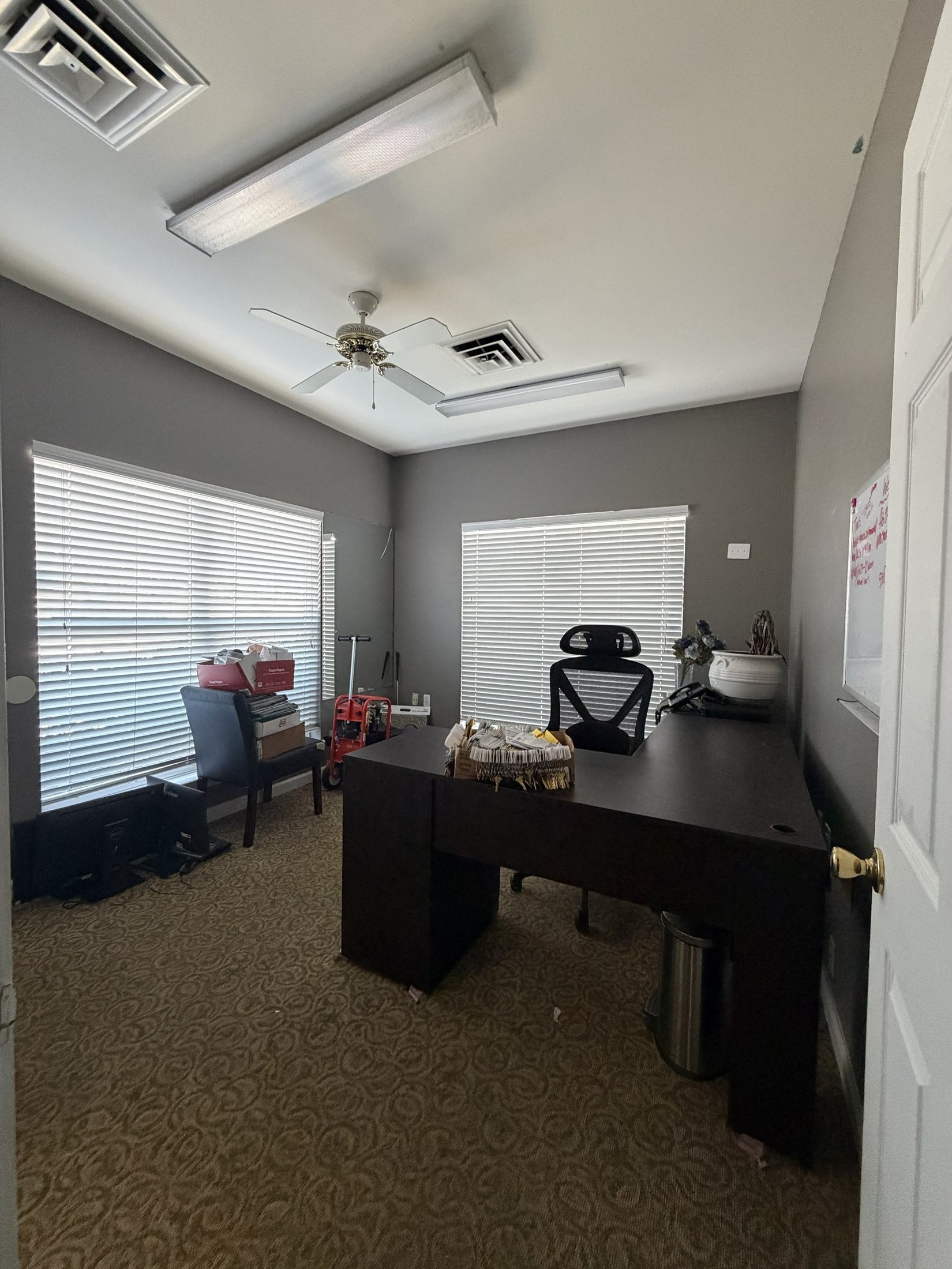 Before: a dark office with carpet, blinds and a heavy desk