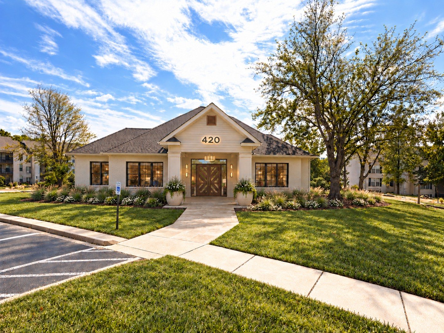 After: the redesigned clubhouse with ivory facade, walnut chevron doors and lush landscaping