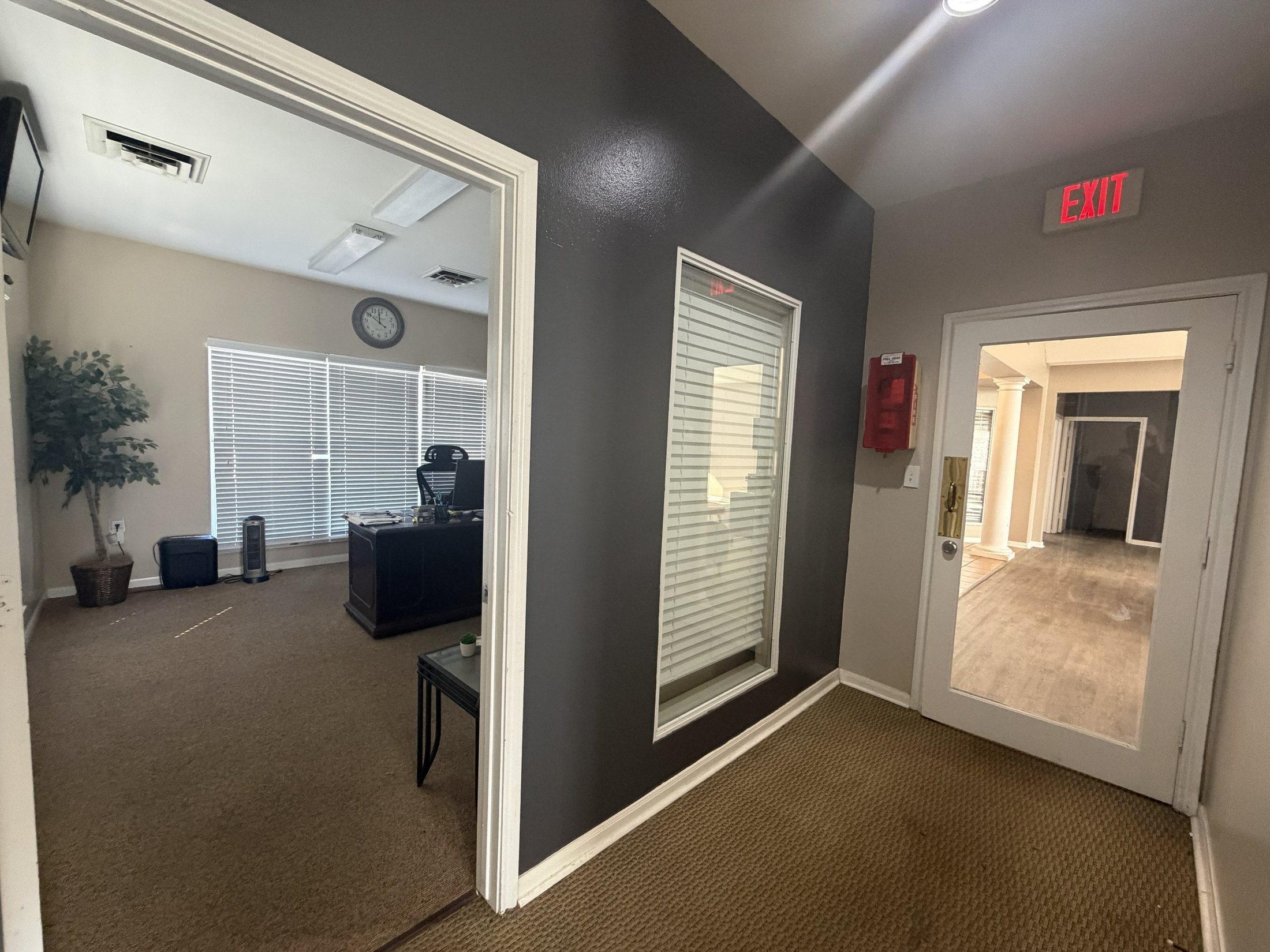 Before: an office space with dark walls and carpet