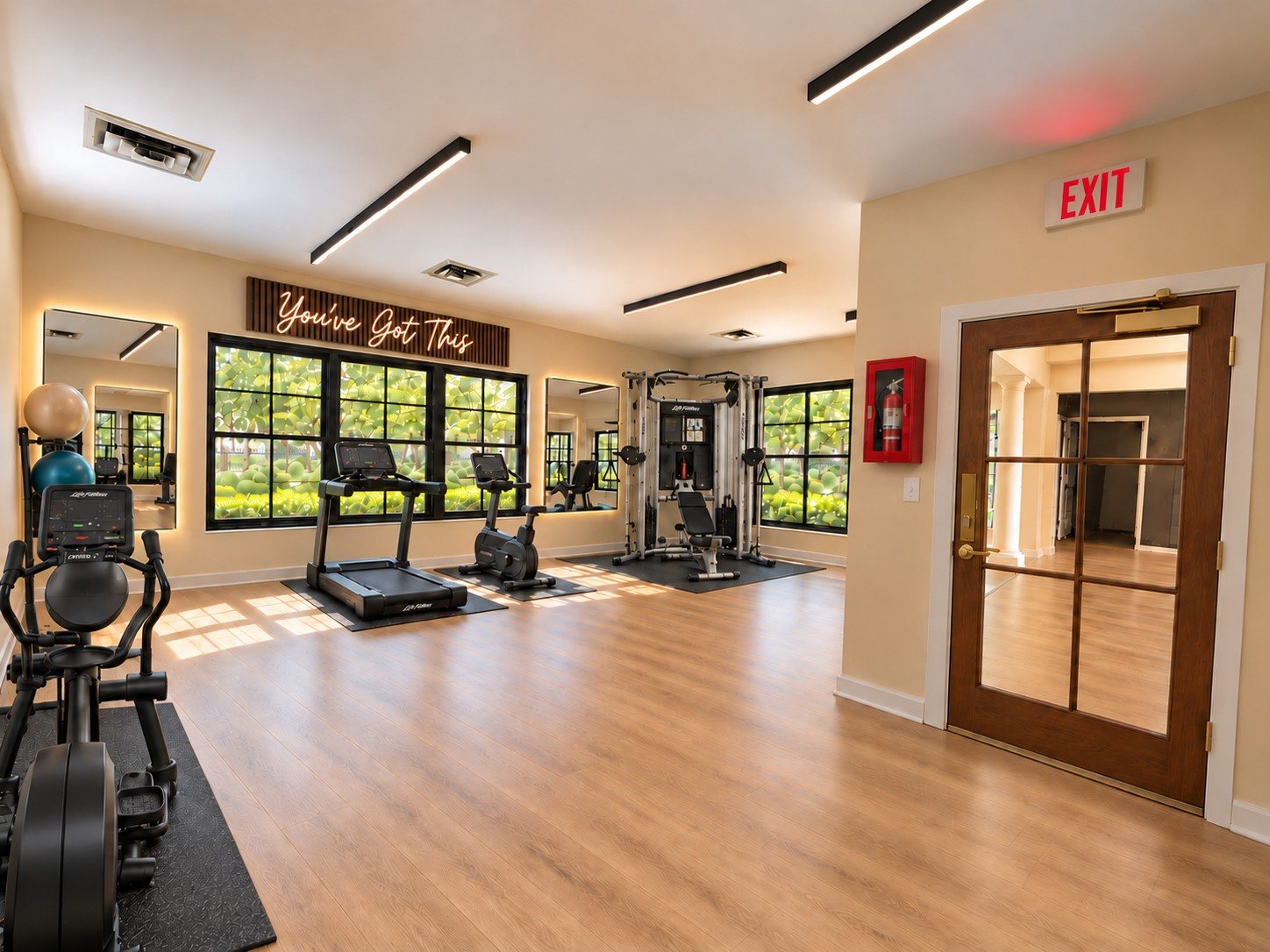 After: a fitness studio with treadmills, a cable machine, oak floors and a neon sign