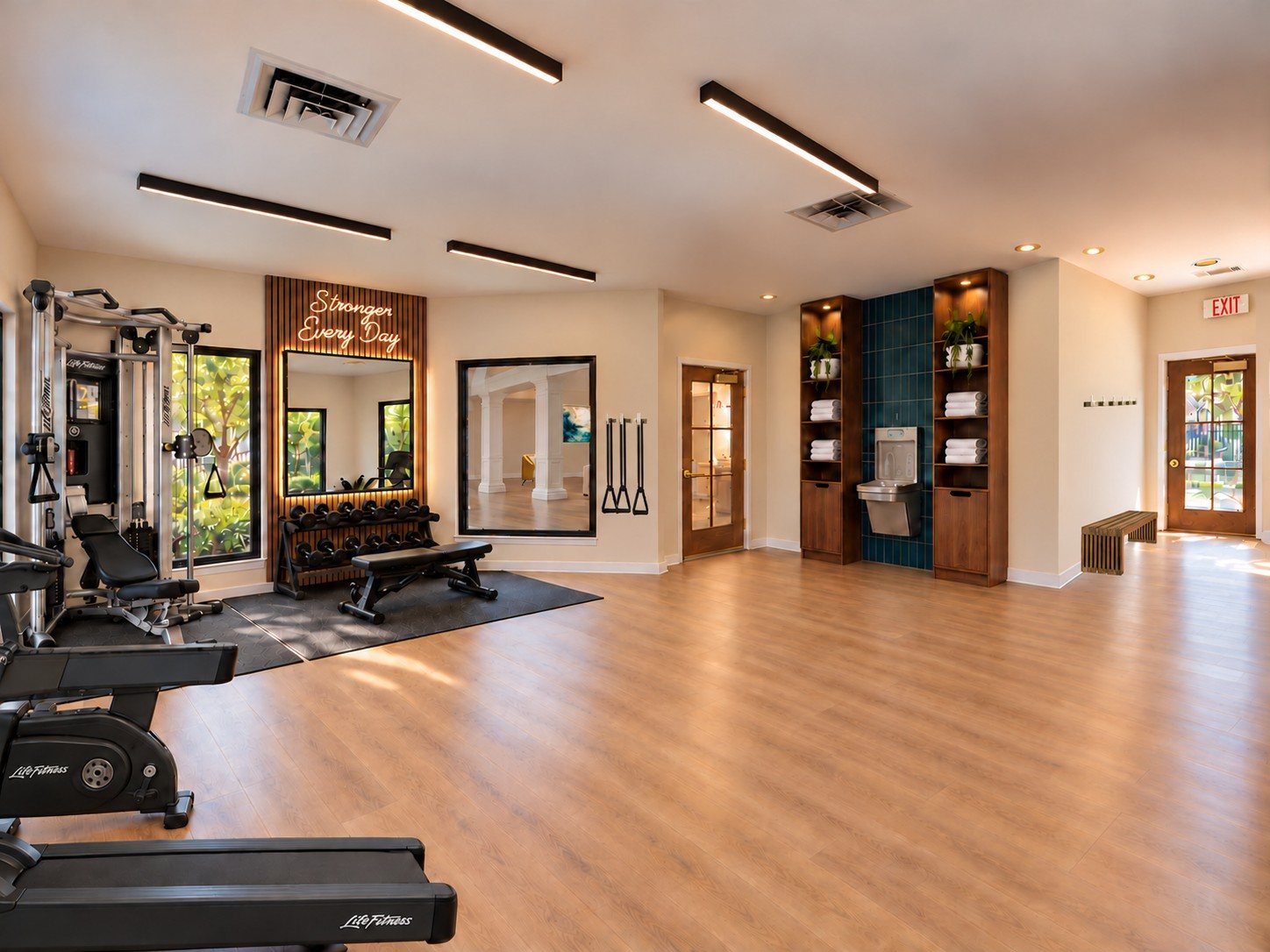 After: the fitness studio with free weights, mirrors and walnut shelving on teal tile